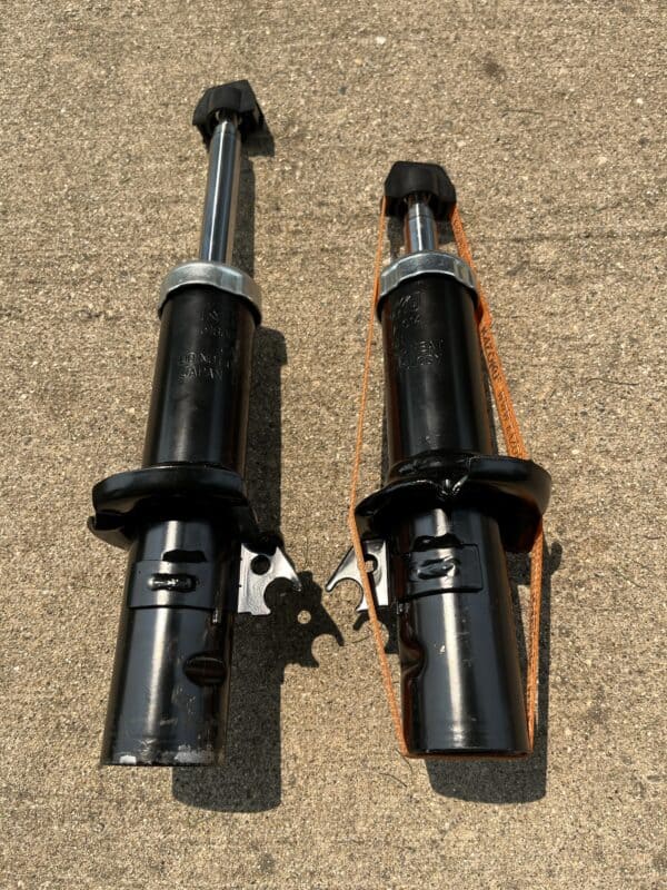 New motorcycle front suspension forks for performance upgrade, installed for improved handling and ride quality. High-quality suspension parts designed for optimal motorcycle performance.