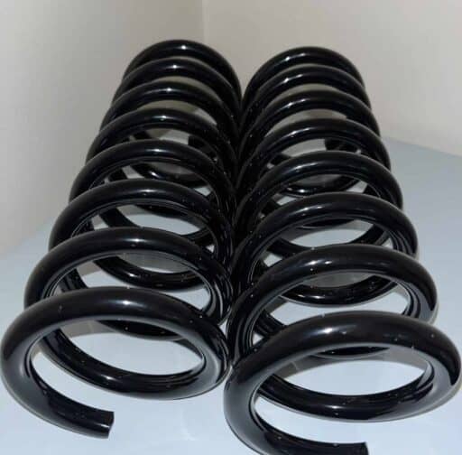 Black coil springs for vehicle suspension, optimized for performance and durability. Essential automotive suspension components for improved handling and ride comfort.