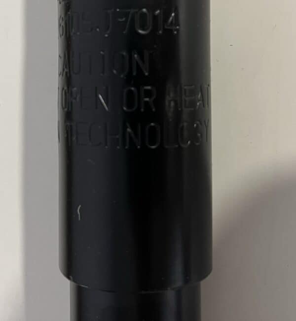 Engraved metal component with safety warnings and specifications, likely part of fitness or performance equipment from Willpowered Performance.