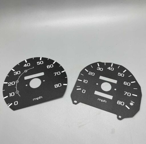 Black and white car speedometer faceplates, digital gauges for vehicle dashboards, precision automotive parts for speed and mileage measurement, ideal for car enthusiasts and performance upgrades.
