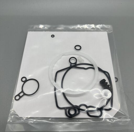 Rubber and metal engine gaskets and O-rings on a white background, automotive repair, high-quality replacement parts for performance vehicles, Willpowered Performance.