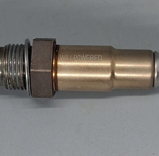 A close-up of a Willpowered Performance spark plug showing high-quality metal construction, designed for enhanced vehicle performance and reliability.