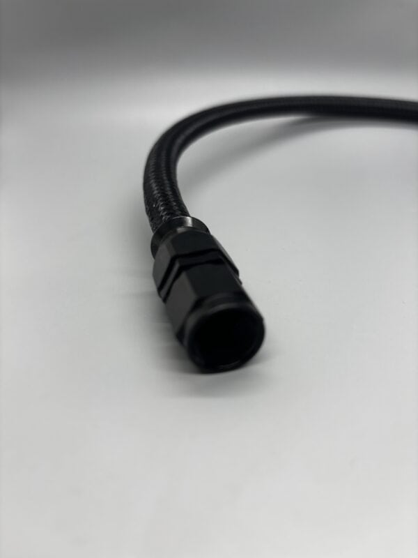 Close-up of a 2 AN x 2ft black hose with straight fittings, suitable for automotive or industrial fluid transfer applications.