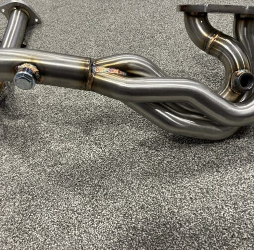 High-performance Acty exhaust header HA-3/4 with polished stainless steel finish, designed for enhanced engine airflow and power output.